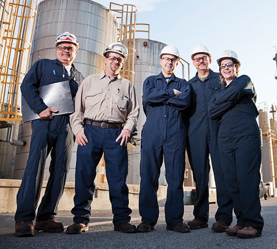 Group of industrial workers at chemical plant