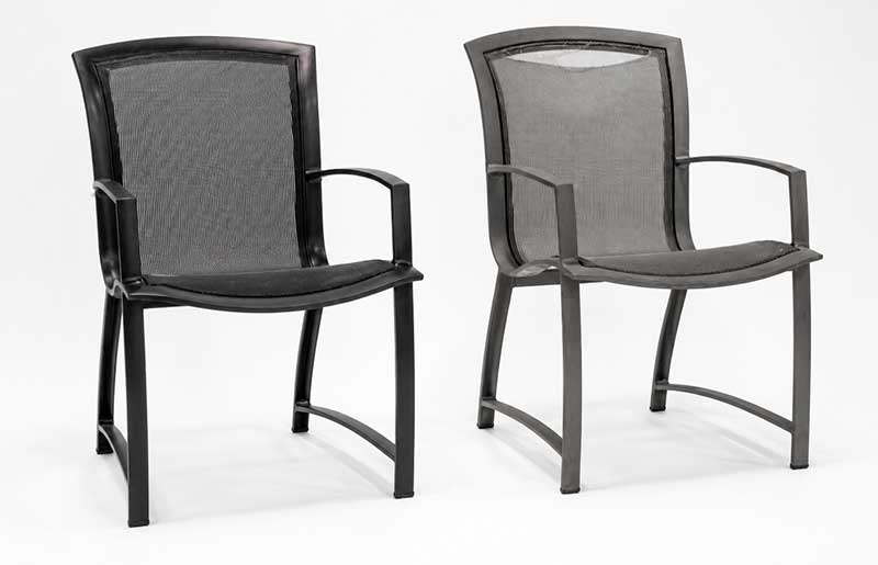 Pair of black sling dining chairs with arms on a white background