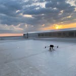 Drone on a rooftop during sunrise