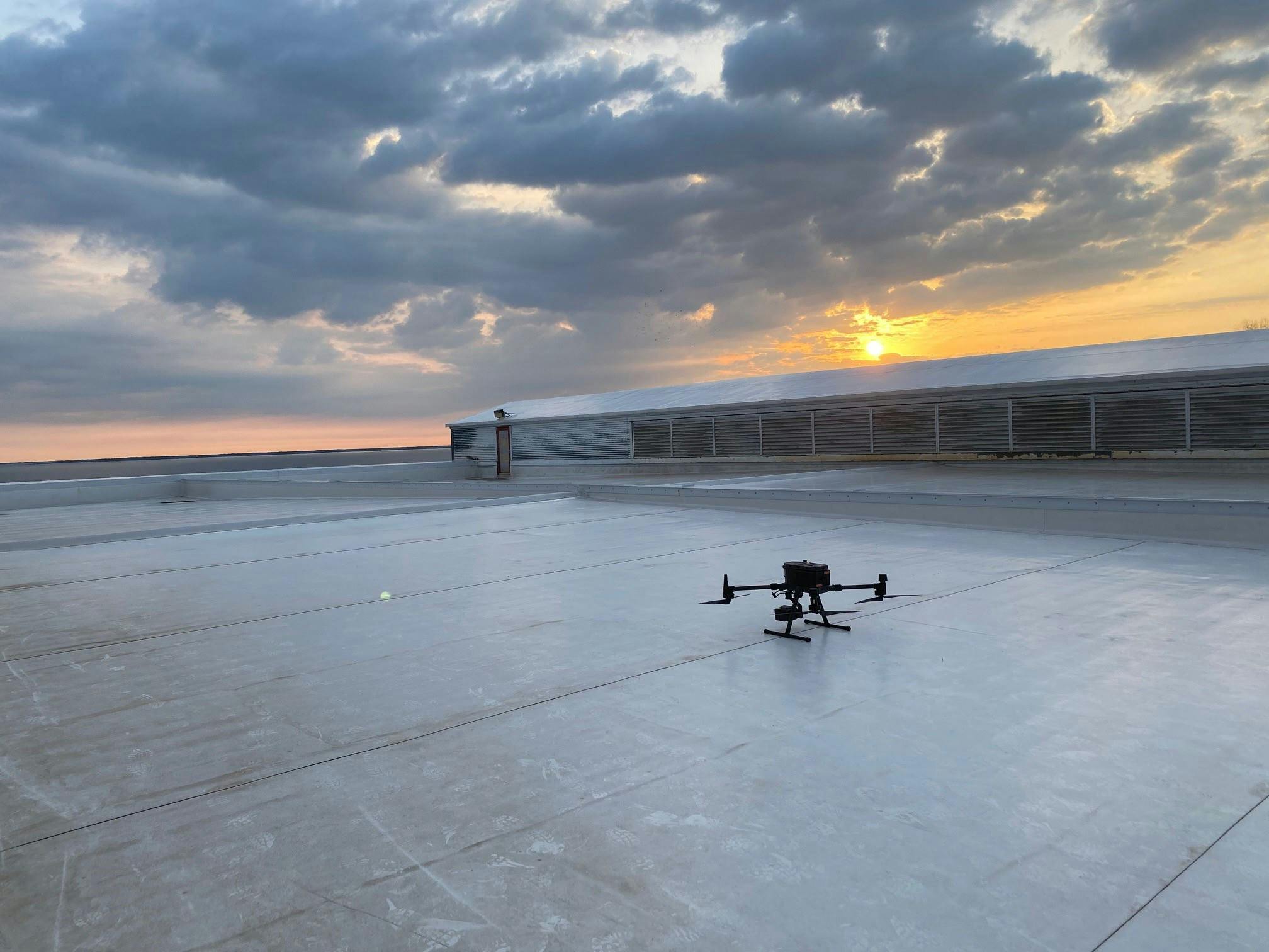 Drone on a rooftop during sunrise