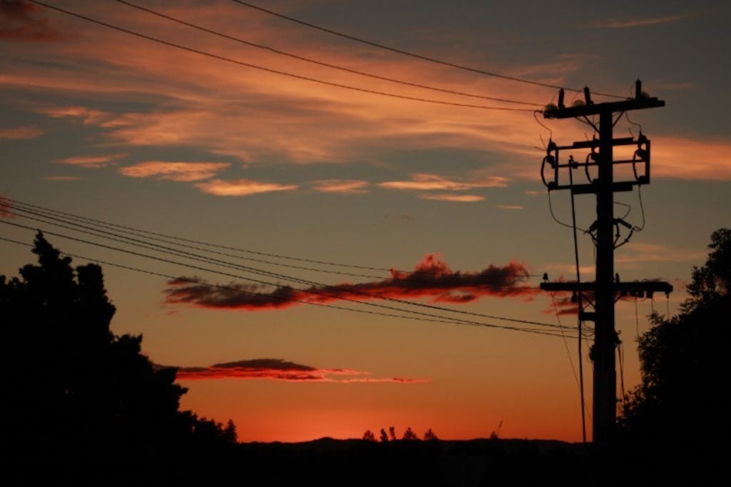 Utility poles at sunset