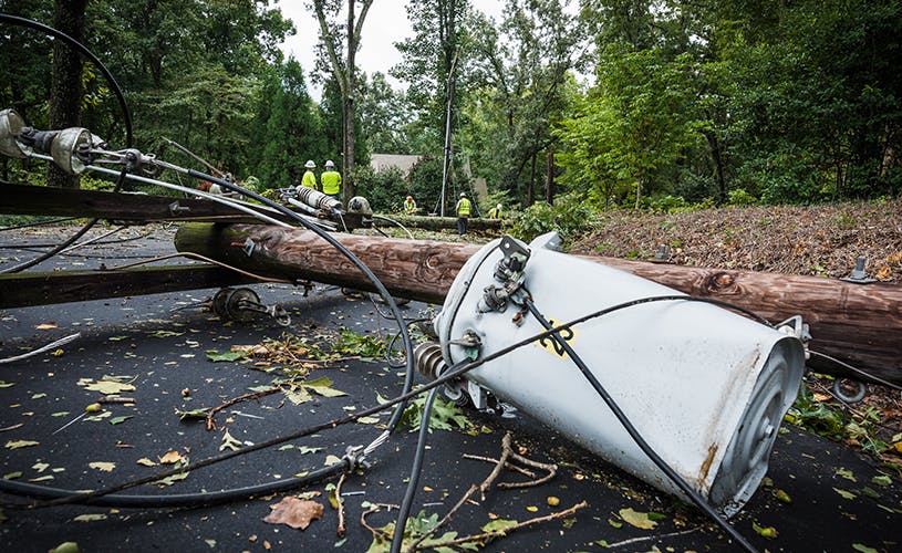 Image of fallen power lines and electrical equipment in a residential neighborhood.