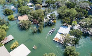 Aerial view of central Texas submerged underwater after a major flooding natural disaster, with an entire community and neighborhood flooded during search and rescue operations.