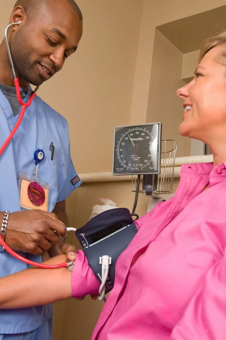 Nurse checking a patients blood pressure