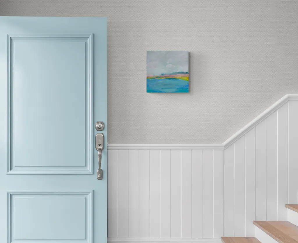 Painting by mandy morroni hung on a wall in a room.