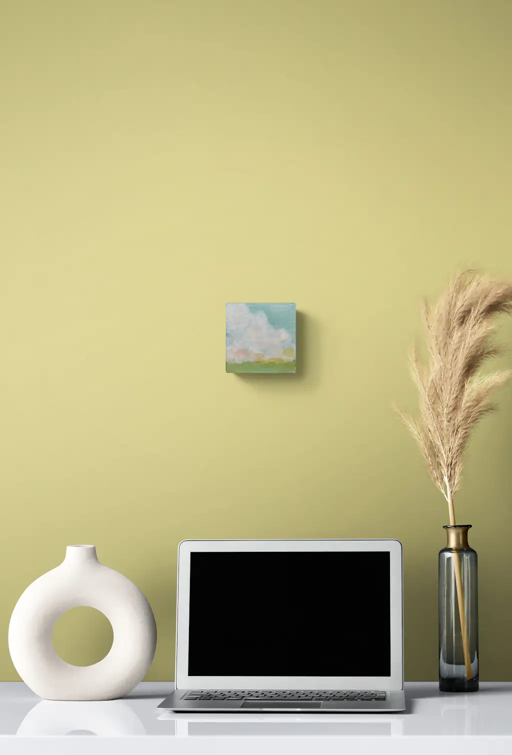 Painting by mandy morroni hung on a wall in a room.