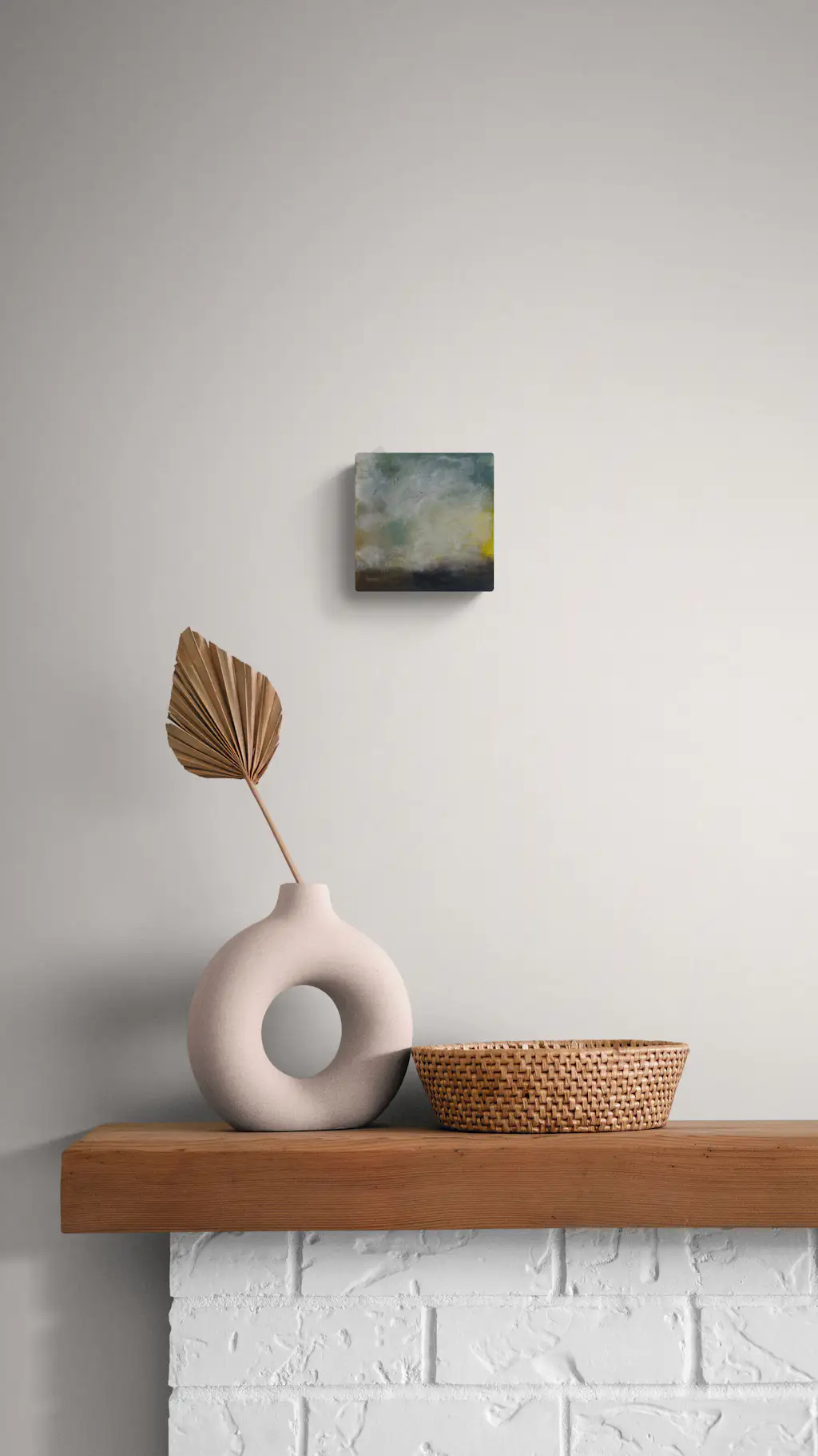 Painting by mandy morroni hung on a wall in a room.