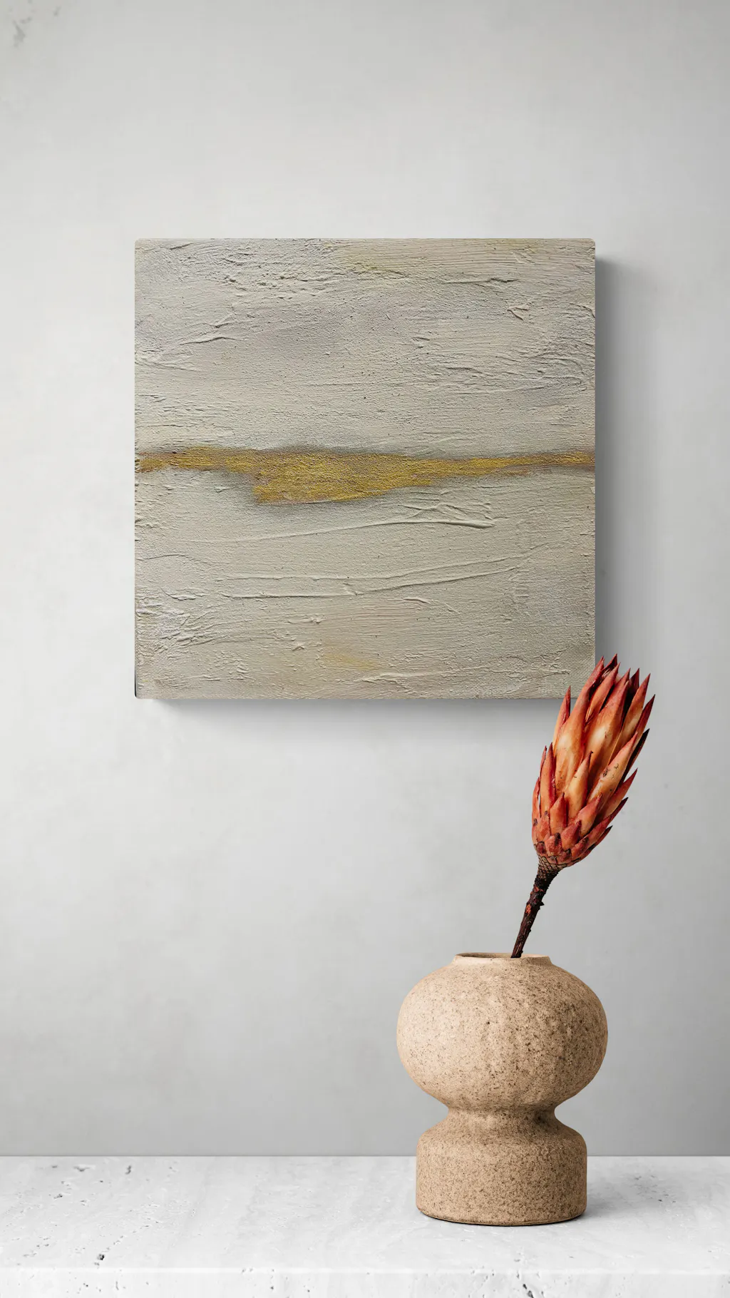 Painting by mandy morroni hung on a wall in a room.