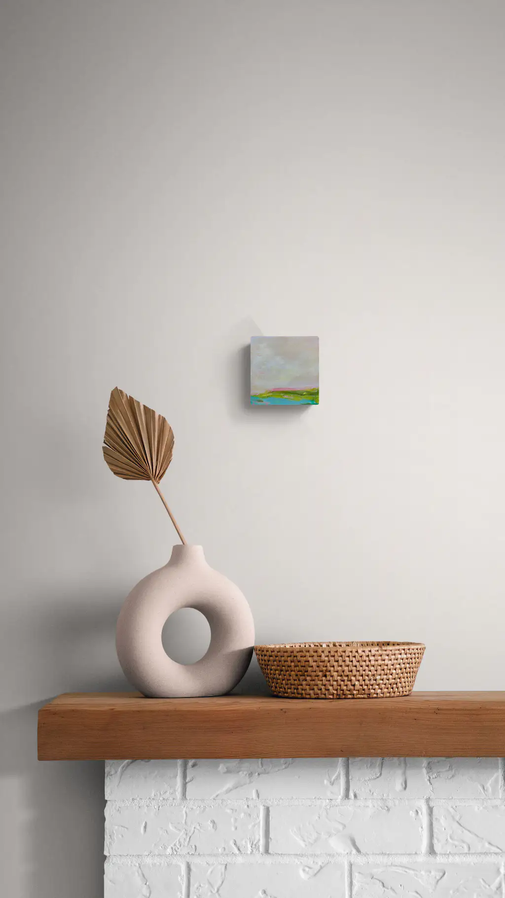 Painting by mandy morroni hung on a wall in a room.