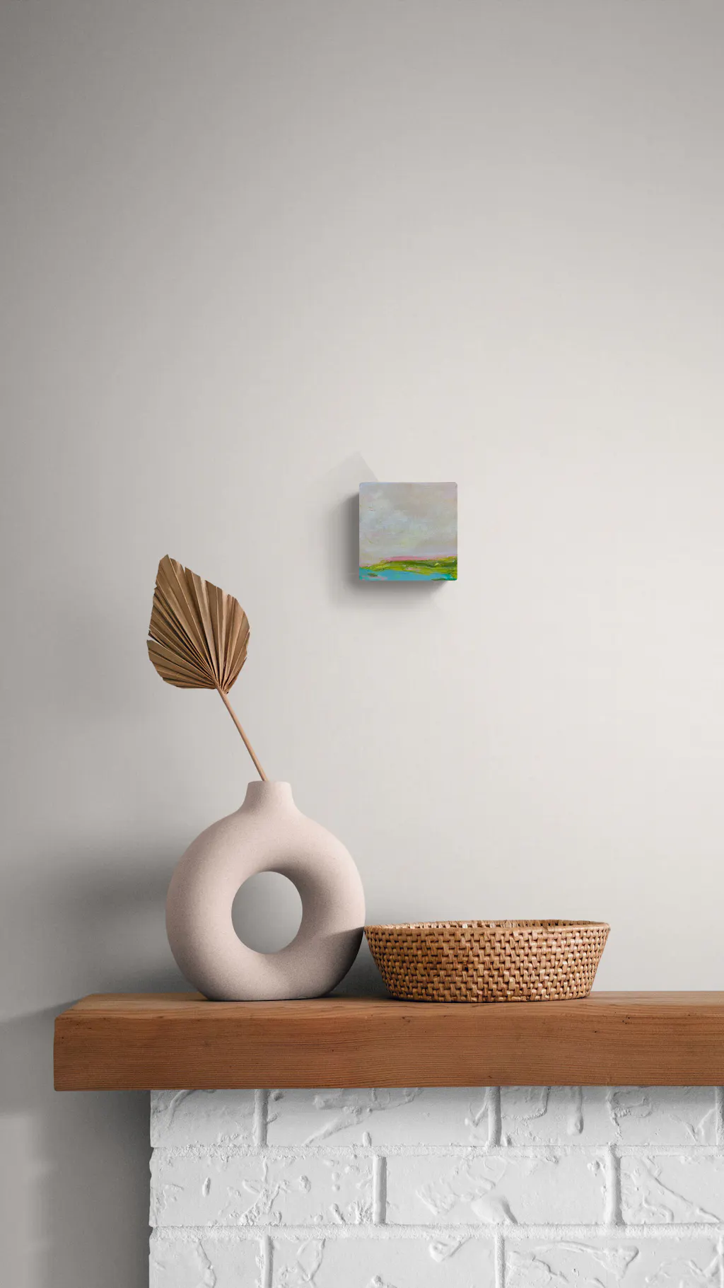 Painting by mandy morroni hung on a wall in a room.