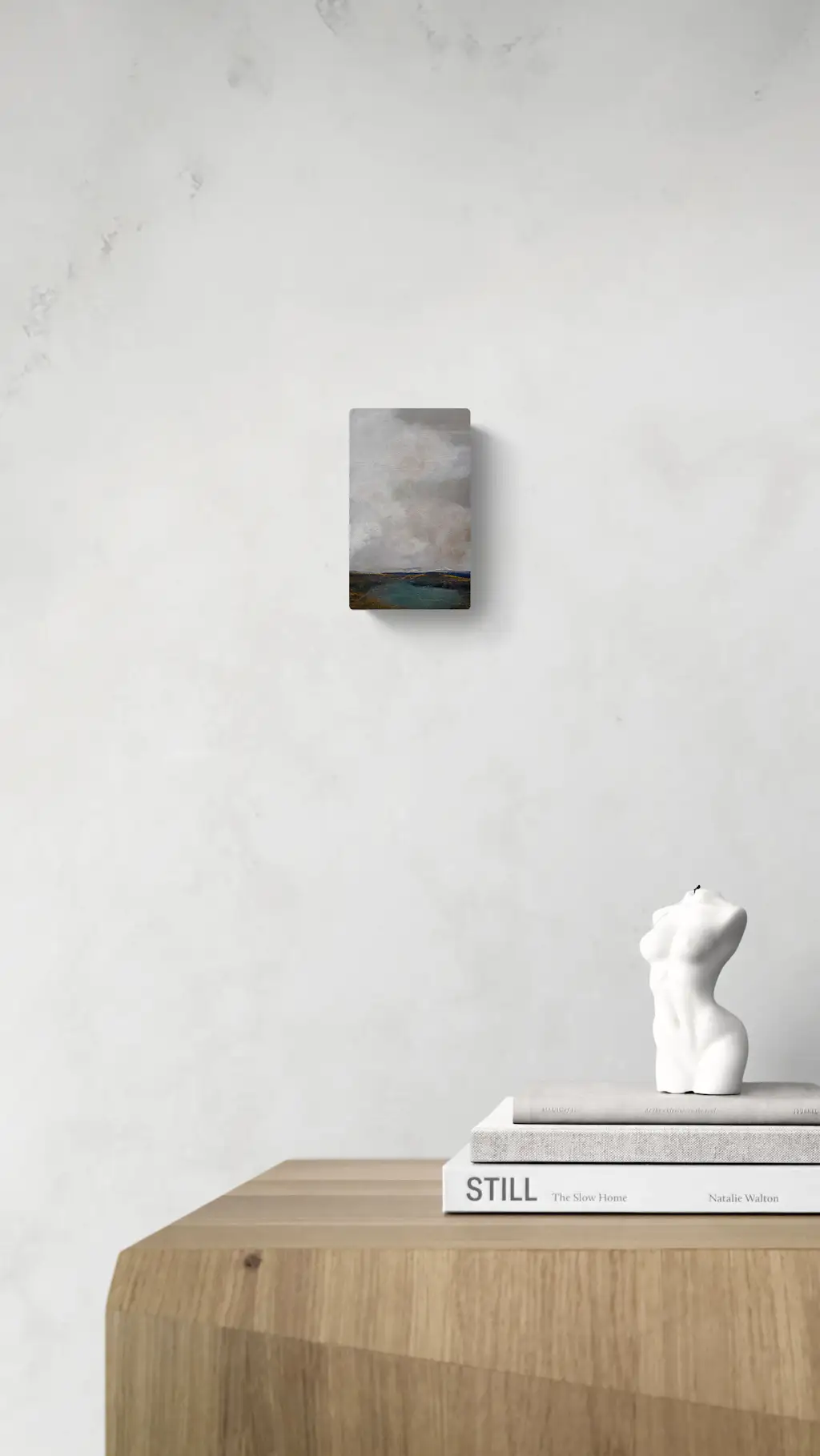 Painting by mandy morroni hung on a wall in a room.