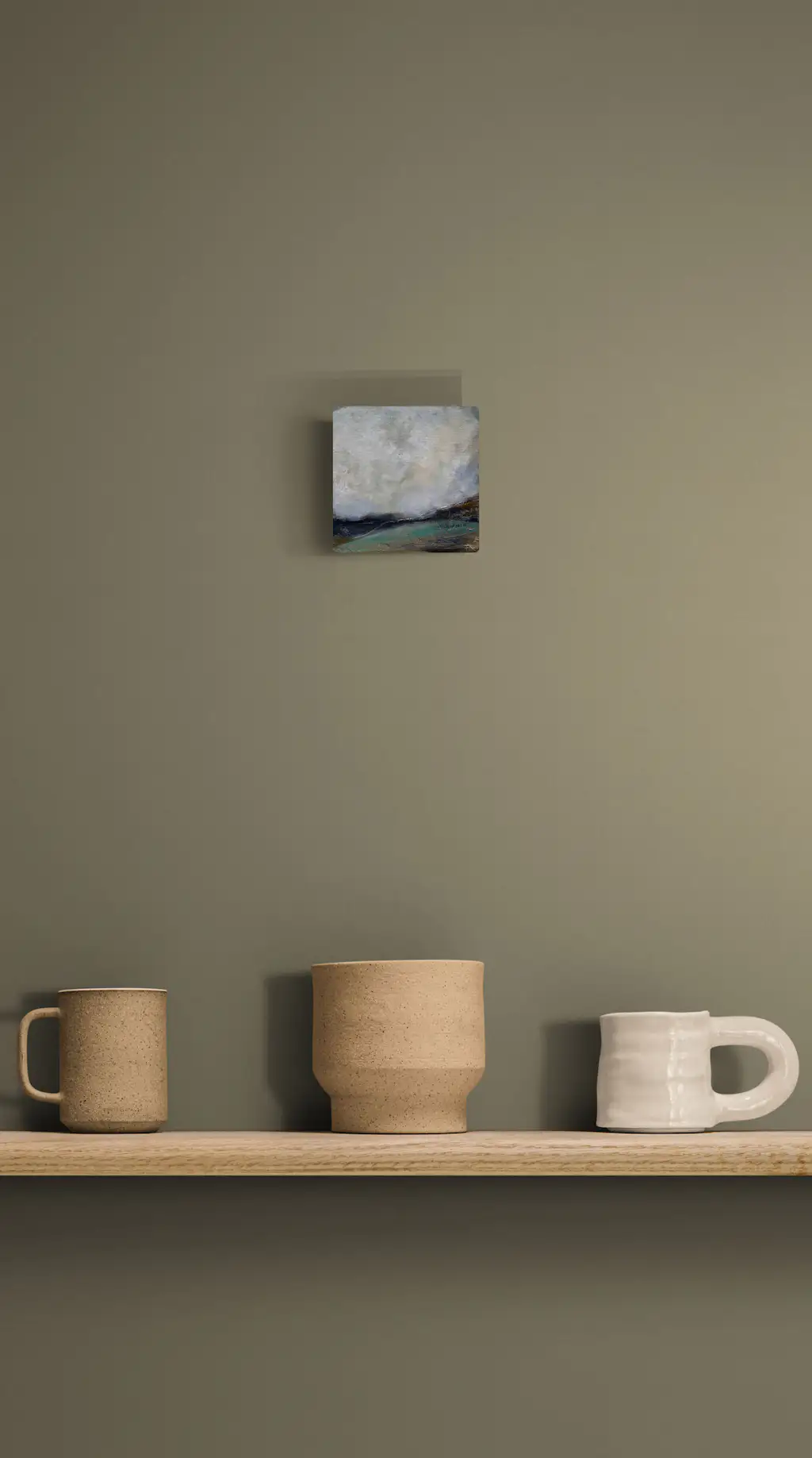 Painting by mandy morroni hung on a wall in a room.