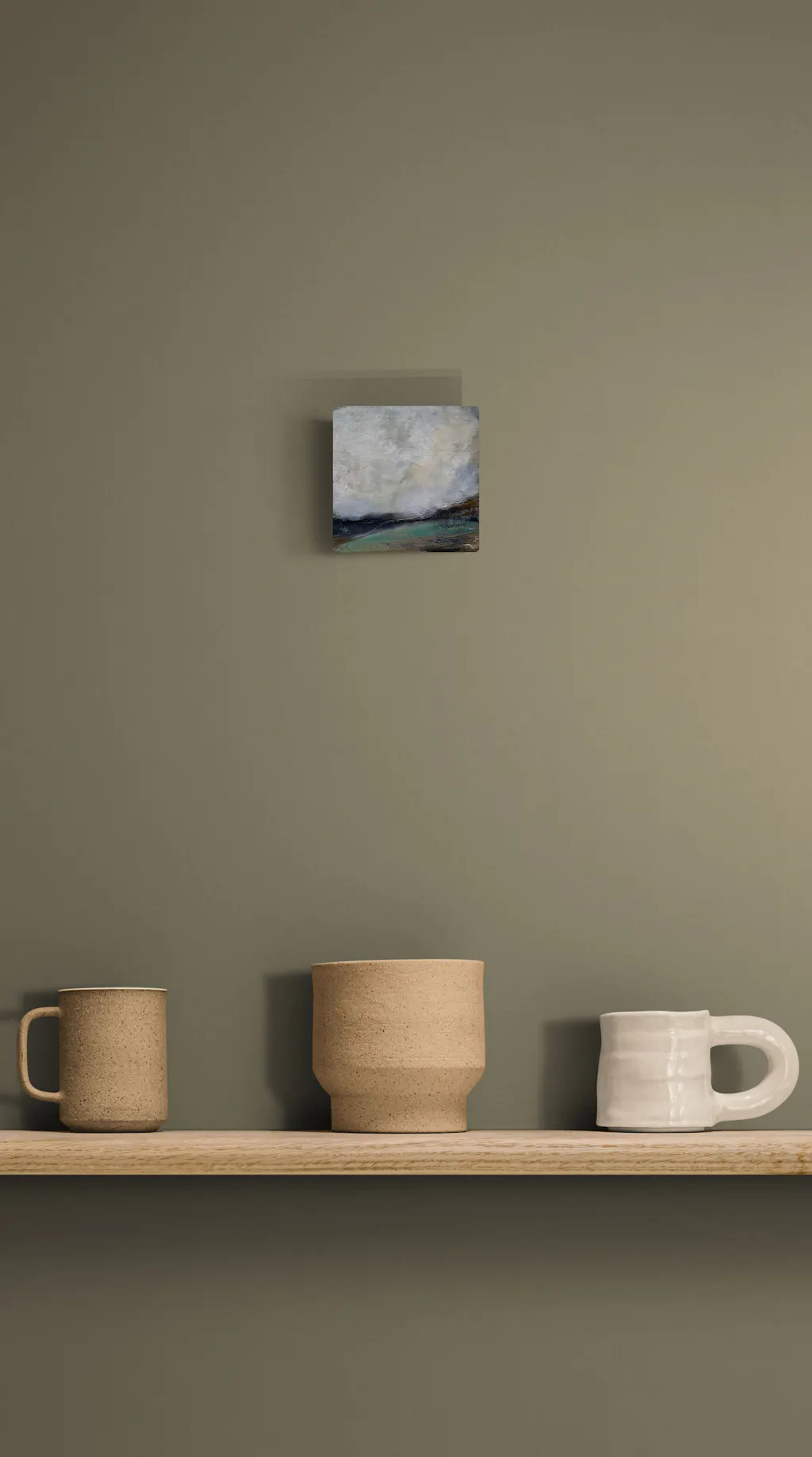 Painting by mandy morroni hung on a wall in a room.