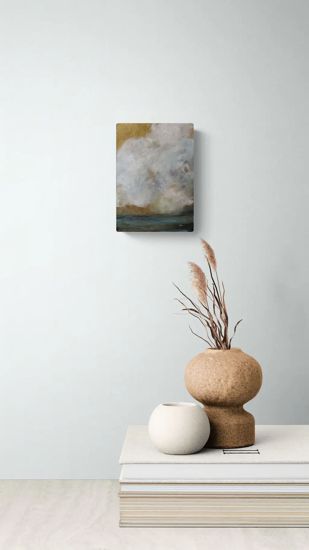 Painting by mandy morroni hung on a wall in a room.