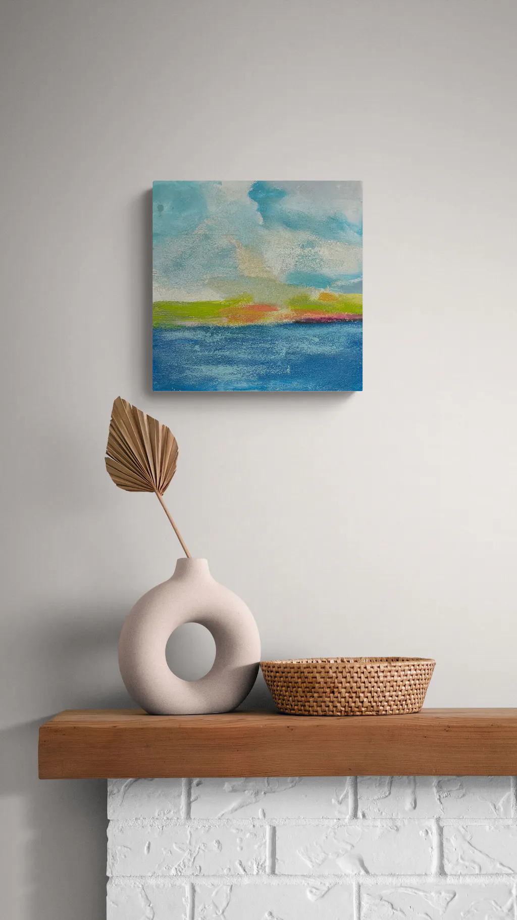 Painting by mandy morroni hung on a wall in a room.