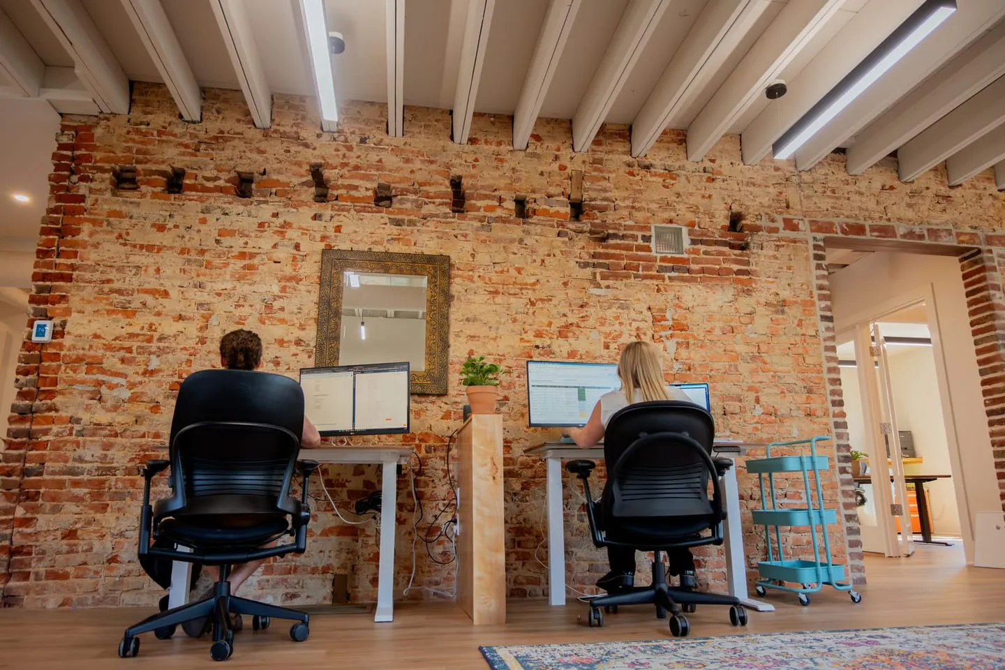 Media Proper desks along the original brick wall of the Media, PA office
