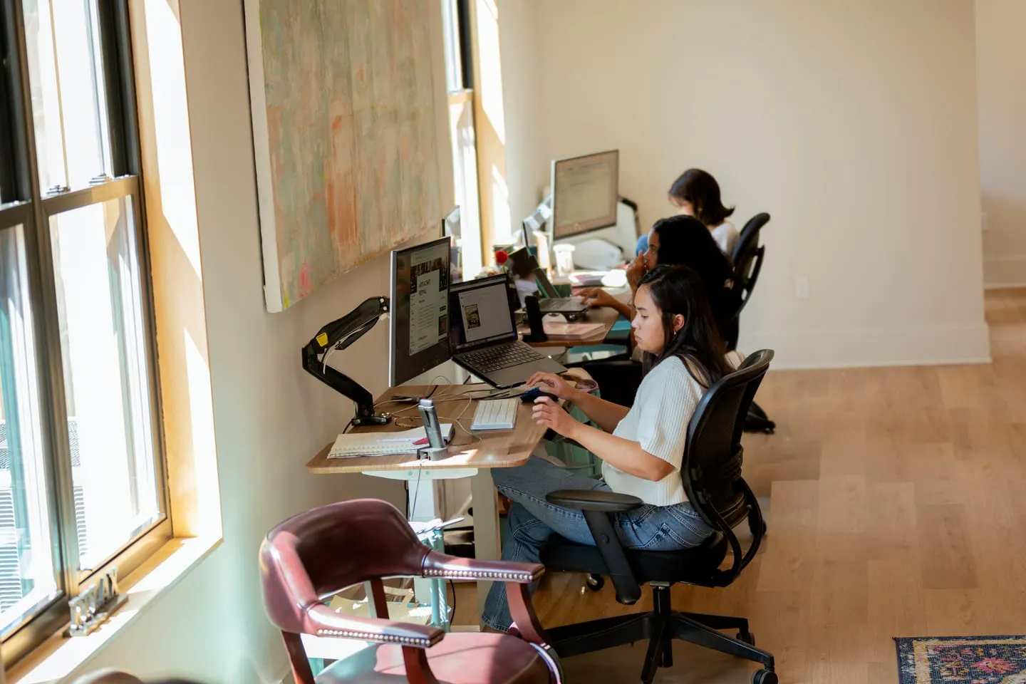 Media Proper team members at their desks along the studio windows