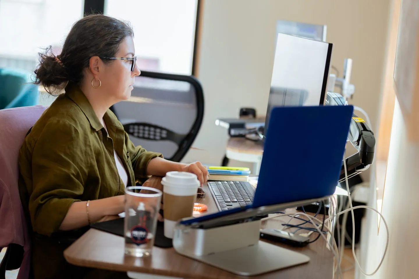 A Media Proper designer working at a laptop in the studio