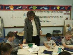 Sr. Connie offers a suggestion to help this little boy with his work.