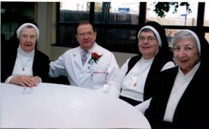 Sr. Ann Joseph chats with Srs. Albert Mary McSwiggin and Georgina Marmino and one of the medical center physicians.