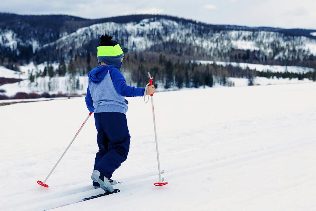 a young boy skiing on snow