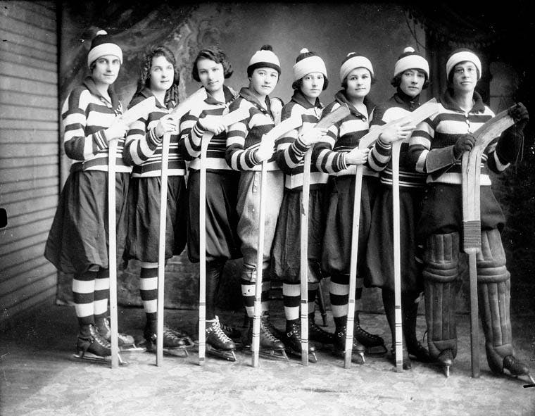 women play ice hockey