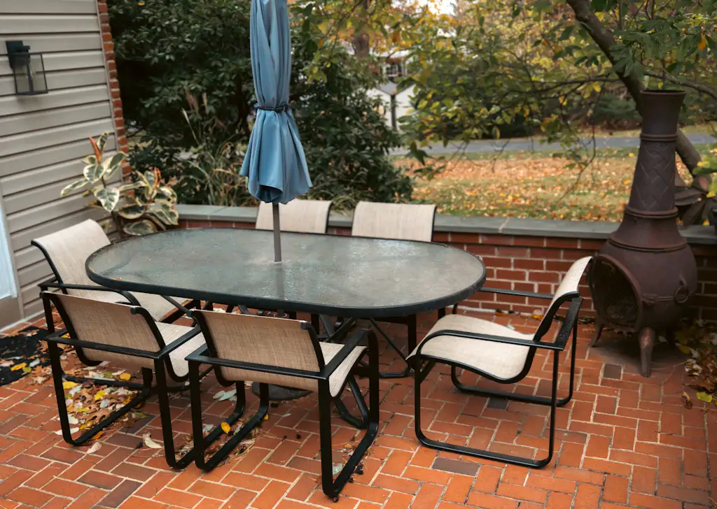 A restored patio dining set with fresh slings on a brick patio