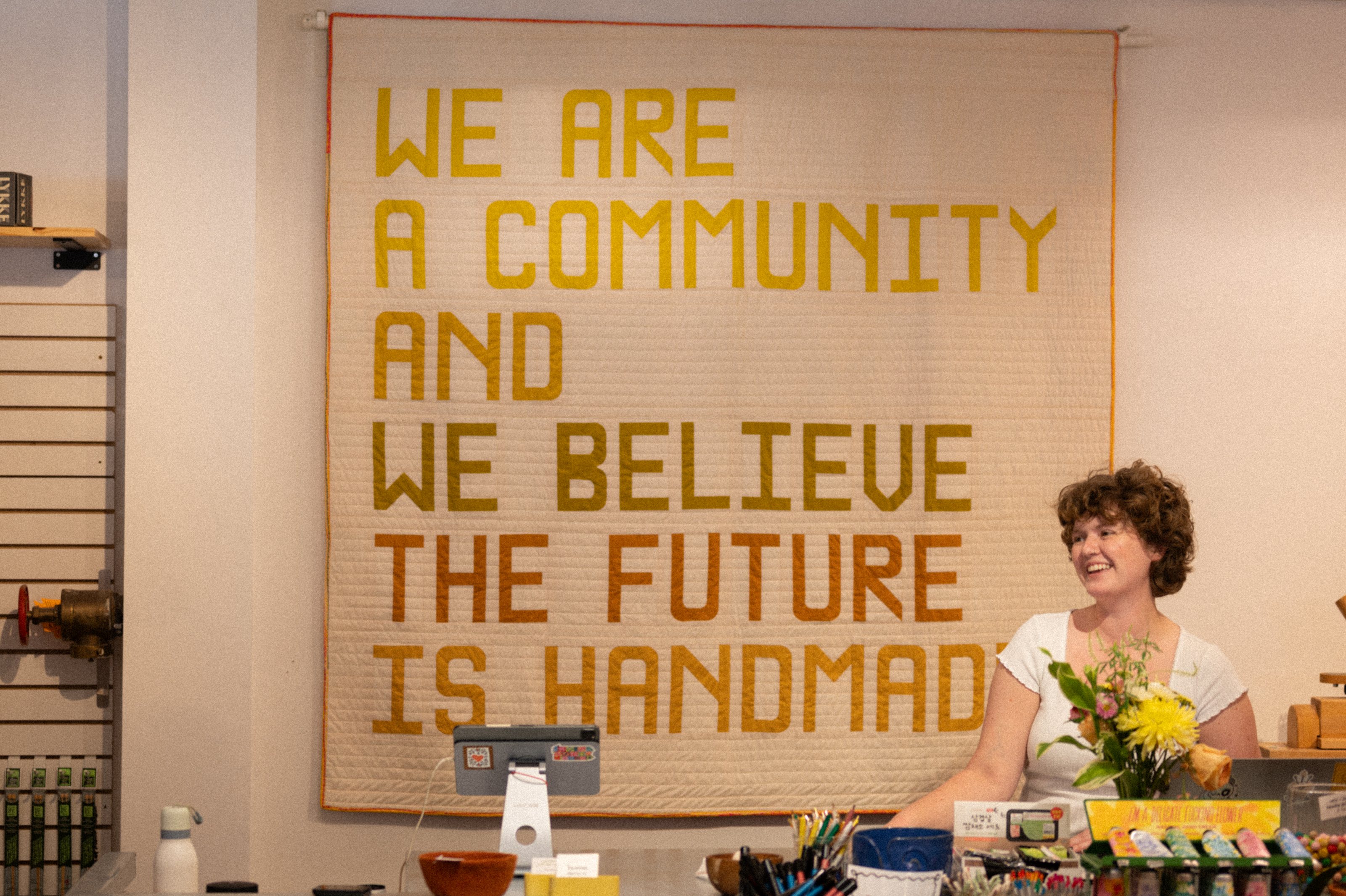 “We are a community and we believe the future is handmade” banner in a Media shop