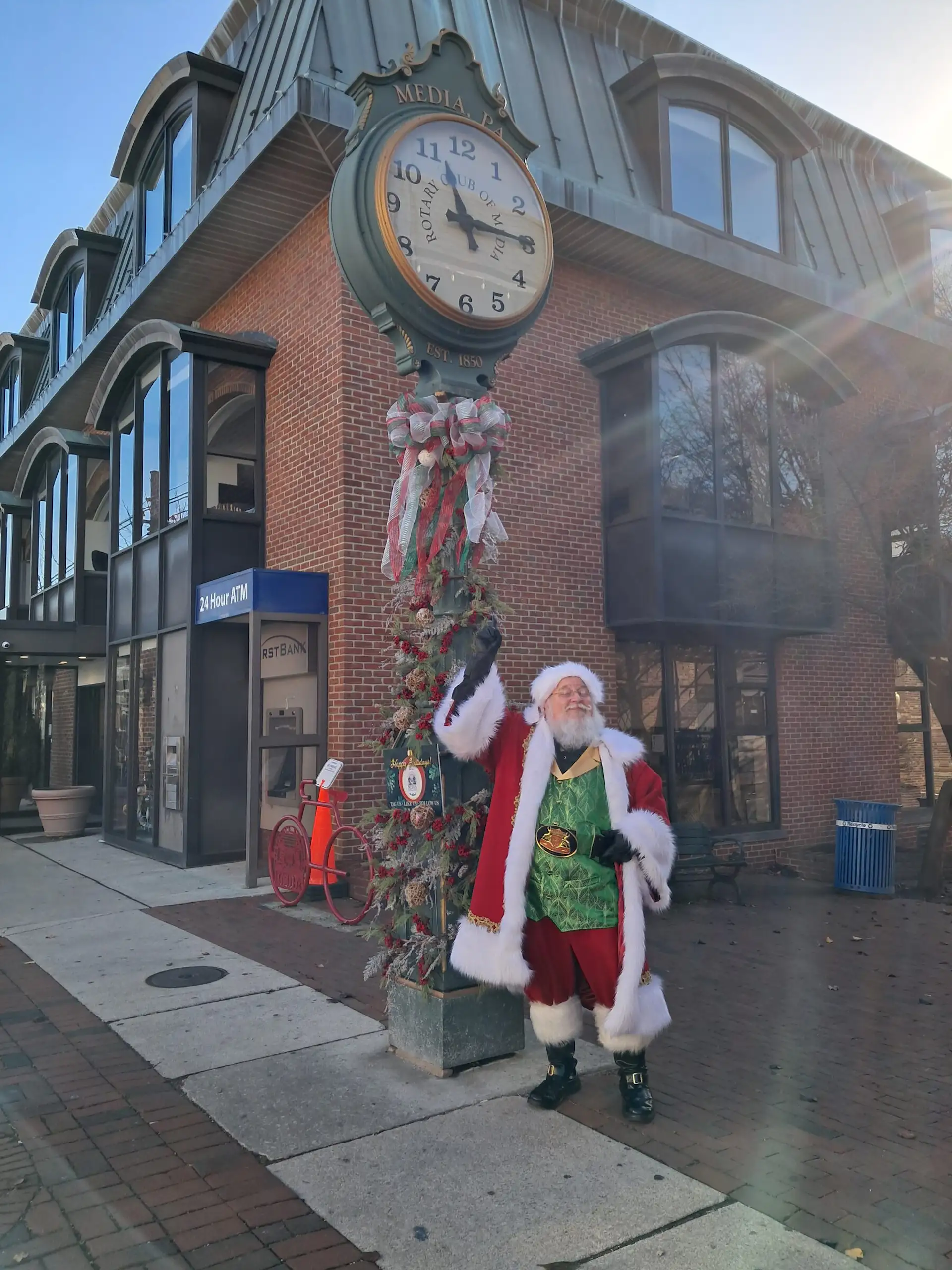 Santa by the State Street clock outside First Bank