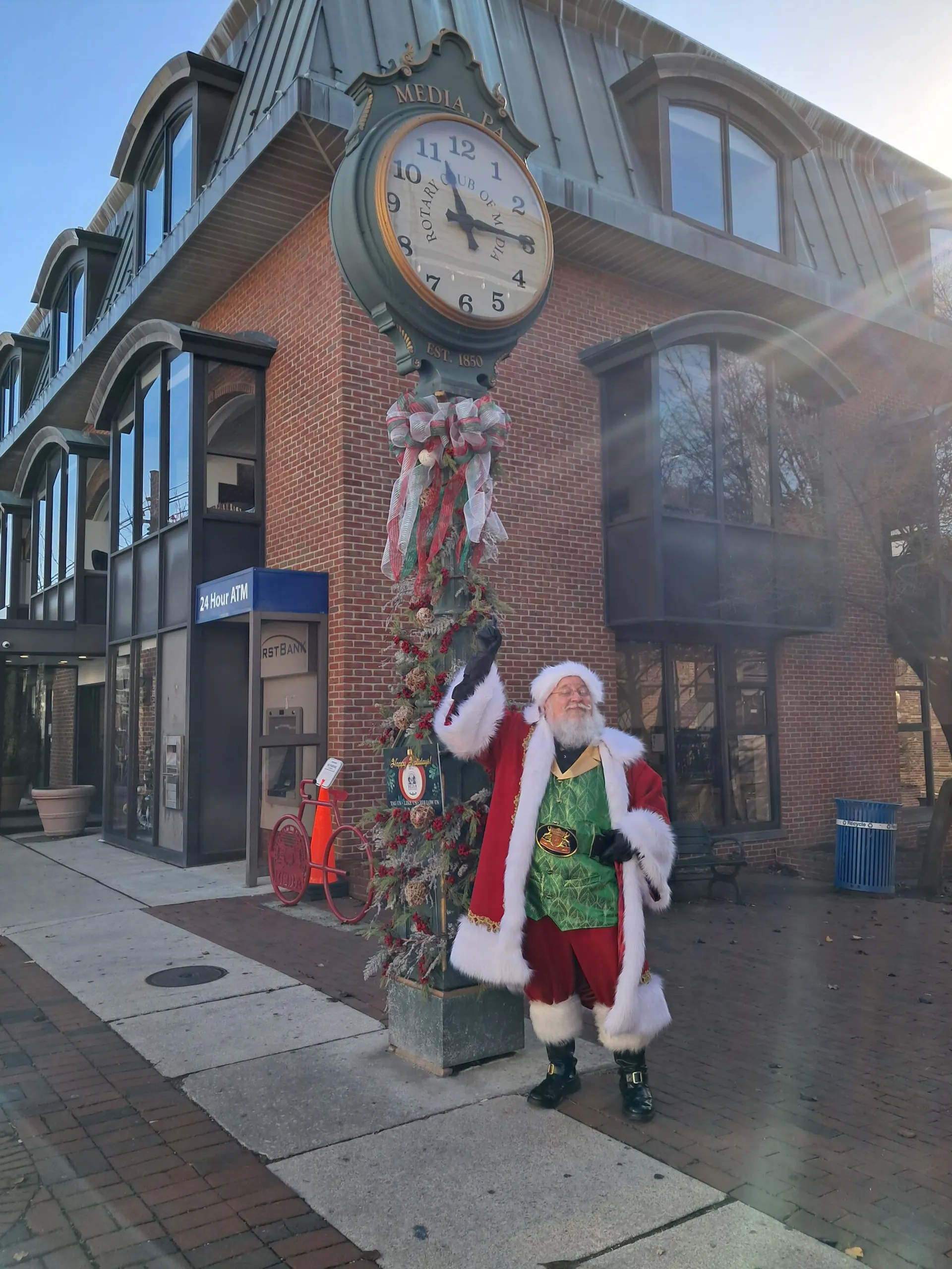 Santa by the State Street clock outside First Bank